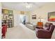 Inviting living room with plush carpet, relaxed seating, fan, and a view of the staircase at 5026 Celtic Ct, Raleigh, NC 27612
