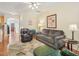 Cozy living room with wood floors, comfortable seating, ceiling fan, and decorative wall art at 5026 Celtic Ct, Raleigh, NC 27612