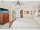 Bright main bedroom with a ceiling fan, a flatscreen TV, and an ensuite bathroom at 5026 Celtic Ct, Raleigh, NC 27612