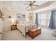 Bright main bedroom featuring tray ceilings, a ceiling fan, and a large window for ample natural light at 5026 Celtic Ct, Raleigh, NC 27612