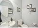 Stylish powder room with modern fixtures, vanity, and neutral color palette at 5026 Celtic Ct, Raleigh, NC 27612