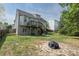 Backyard with a multilevel deck, patio, and stone fire pit at 503 Bellefont Ct, Knightdale, NC 27545