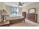 Bright bedroom featuring a ceiling fan and wood furniture at 503 Bellefont Ct, Knightdale, NC 27545