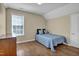 Bedroom with light-colored walls, hardwood floors, a window, and a bed with blue bedding at 503 Bellefont Ct, Knightdale, NC 27545