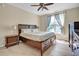 Bright bedroom featuring a ceiling fan and wood furniture at 503 Bellefont Ct, Knightdale, NC 27545