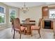 Charming dining room with a glass-top table, chandelier, and a view into the adjacent kitchen area at 503 Bellefont Ct, Knightdale, NC 27545