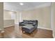 Living room with a plush leather couch, TV, and hardwood floors at 503 Bellefont Ct, Knightdale, NC 27545