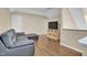 Living room with a plush leather couch, TV, and hardwood floors at 503 Bellefont Ct, Knightdale, NC 27545