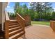 Wooden back deck overlooking a lush backyard and is accessible via a staircase at 503 Mugo Pine Ct, Wendell, NC 27591