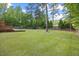 Expansive backyard featuring lush greenery and playground equipment, ideal for outdoor enjoyment at 503 Mugo Pine Ct, Wendell, NC 27591