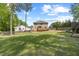 Grassy backyard featuring a wooden deck and play area with slide and swings for outdoor fun at 503 Mugo Pine Ct, Wendell, NC 27591