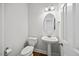 Elegant powder room featuring a pedestal sink, and modern fixtures, adding a touch of luxury to the home at 503 Mugo Pine Ct, Wendell, NC 27591