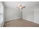 Neutral bedroom with a ceiling fan, a window and a door provides a comforting space at 503 Mugo Pine Ct, Wendell, NC 27591