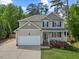 Inviting home with a two-car garage, manicured lawn, and a charming front porch at 503 Mugo Pine Ct, Wendell, NC 27591