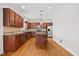 Modern kitchen features a center island, stainless steel appliances, and hardwood flooring for gourmet cooking at 503 Mugo Pine Ct, Wendell, NC 27591