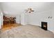 Open living room boasts a modern fireplace, carpet floors, and seamlessly connects to a gourmet kitchen at 503 Mugo Pine Ct, Wendell, NC 27591