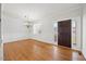 Spacious living room features hardwood floors, crown molding, and ample natural light from a window and the front door at 503 Mugo Pine Ct, Wendell, NC 27591