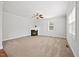 Bright living room features a modern fireplace, ceiling fan, and plush carpet, creating a cozy ambiance at 503 Mugo Pine Ct, Wendell, NC 27591