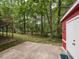 Private backyard with concrete patio and small red outbuilding provides space for outdoor entertaining and storage at 508 Colony Woods Dr, Chapel Hill, NC 27517