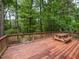 Outdoor deck overlooking the wooded backyard with a picnic table at 508 Colony Woods Dr, Chapel Hill, NC 27517