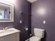 Stylish bathroom features a modern sink and toilet against a beautiful purple wall at 508 Colony Woods Dr, Chapel Hill, NC 27517