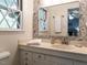 Stylish bathroom features a decorative mirror, vanity with a sink, and patterned wallpaper at 508 Colony Woods Dr, Chapel Hill, NC 27517