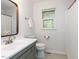 This bright bathroom features a tub, shower, vanity with a sink, and window at 508 Colony Woods Dr, Chapel Hill, NC 27517