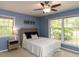 Cozy bedroom featuring a ceiling fan, neutral carpet, and large window offering natural light at 508 Colony Woods Dr, Chapel Hill, NC 27517