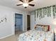 Bright bedroom with fun floral bedding, ceiling fan, and open closet with shelving at 508 Colony Woods Dr, Chapel Hill, NC 27517