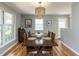 Dining room with natural light, wood floors, and a stylish chandelier above a wooden table at 508 Colony Woods Dr, Chapel Hill, NC 27517