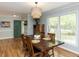 Inviting dining room with wood floors and views of the yard, complemented by a stylish light fixture at 508 Colony Woods Dr, Chapel Hill, NC 27517