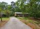 Charming single-story brick home featuring a long driveway, manicured lawn, and mature trees at 508 Colony Woods Dr, Chapel Hill, NC 27517