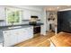Bright kitchen with white cabinets, stainless steel appliances, and an adjacent living space at 508 Colony Woods Dr, Chapel Hill, NC 27517