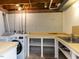 Functional laundry area with modern washer/dryer, utility sink, and ample counter space at 508 Colony Woods Dr, Chapel Hill, NC 27517
