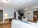 Well-lit living room boasts a modern wet bar and unique tin tile ceiling feature at 508 Colony Woods Dr, Chapel Hill, NC 27517