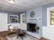 Cozy living room featuring a fireplace, unique ceiling, built-in bookcase, and lots of light at 508 Colony Woods Dr, Chapel Hill, NC 27517