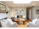Well-lit living room with a brick fireplace, built-in shelving, and comfortable, neutral-toned furniture at 508 Colony Woods Dr, Chapel Hill, NC 27517