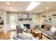 Bright living room with a brick fireplace, wood floors, and a comfortable seating arrangement at 508 Colony Woods Dr, Chapel Hill, NC 27517
