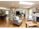 Open-concept living space with skylights, hardwood floors, and a view into the kitchen and dining area at 508 Colony Woods Dr, Chapel Hill, NC 27517