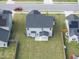 Aerial view of the backyard showcasing a covered patio and well-maintained lawn at 509 National Dr, Clayton, NC 27520