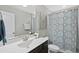 Cozy bathroom featuring a vanity with marble countertop and a shower with stylish, decorative curtain at 509 National Dr, Clayton, NC 27520