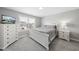 Bright bedroom featuring a bed, window with neighborhood view, dresser, and bedside table at 509 National Dr, Clayton, NC 27520