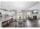 Open-concept dining area with fireplace, wood floors, and view of the kitchen and backyard at 509 National Dr, Clayton, NC 27520