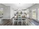 Dining area with wood floors, lighting fixture, and view of the kitchen and backyard at 509 National Dr, Clayton, NC 27520