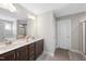 Well-lit main bathroom featuring double sinks with dark wood cabinetry at 509 National Dr, Clayton, NC 27520