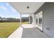 View of the covered patio area with double doors and a grassy backyard at 509 National Dr, Clayton, NC 27520