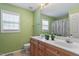 Bathroom with double sinks, wooden cabinets, and shower/tub combo at 5204 Nautical Ln, Raleigh, NC 27610