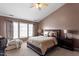 Main bedroom featuring a ceiling fan, a bed, and natural light from windows at 5204 Nautical Ln, Raleigh, NC 27610