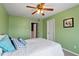 Green bedroom with ceiling fan and furniture at 5204 Nautical Ln, Raleigh, NC 27610
