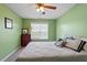 Cozy bedroom with green walls, ceiling fan, and comfortable bed at 5204 Nautical Ln, Raleigh, NC 27610